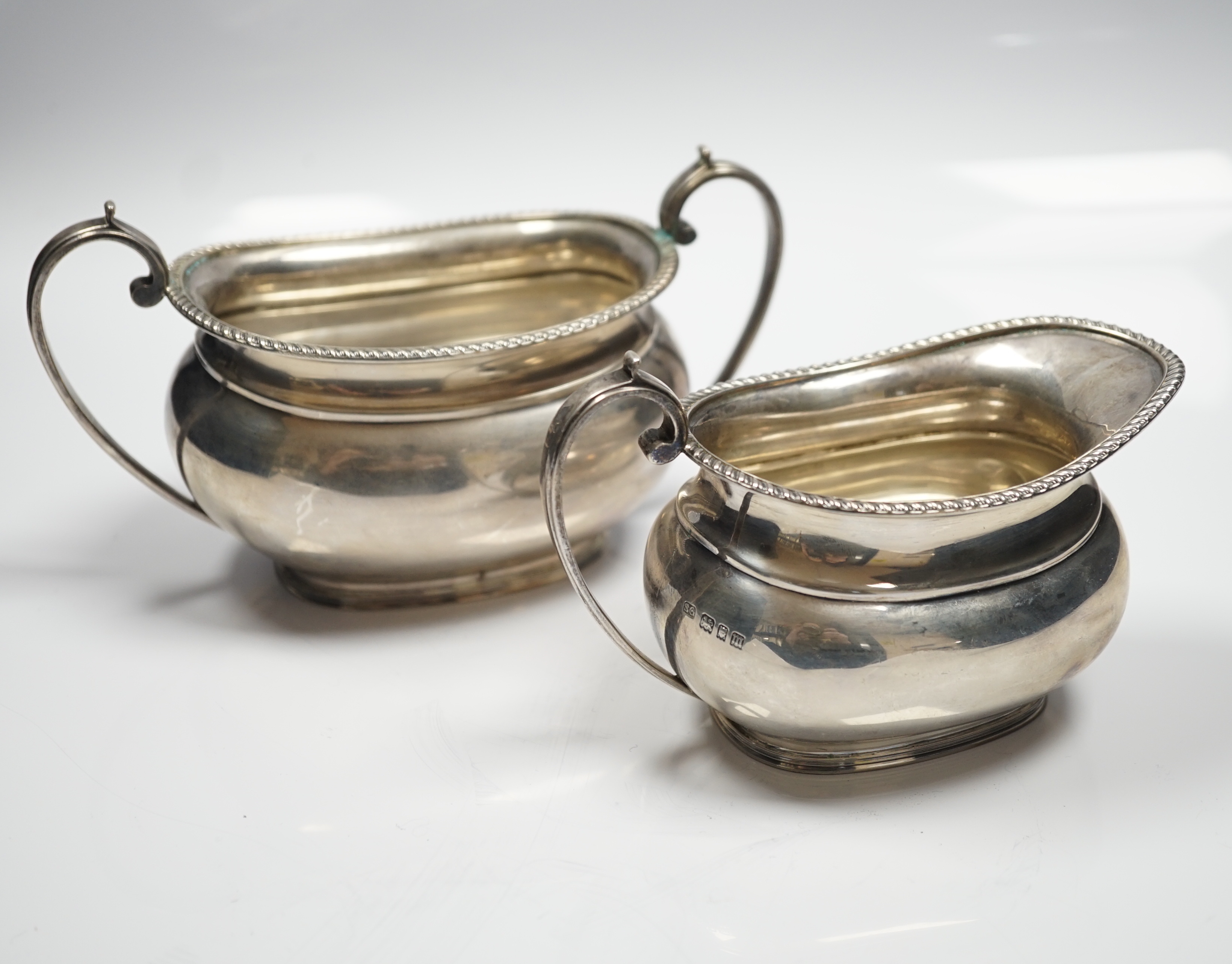 A George V silver oval cream jug and sugar bowl, Sebastian Garrard, London, 1927, 14.8oz.